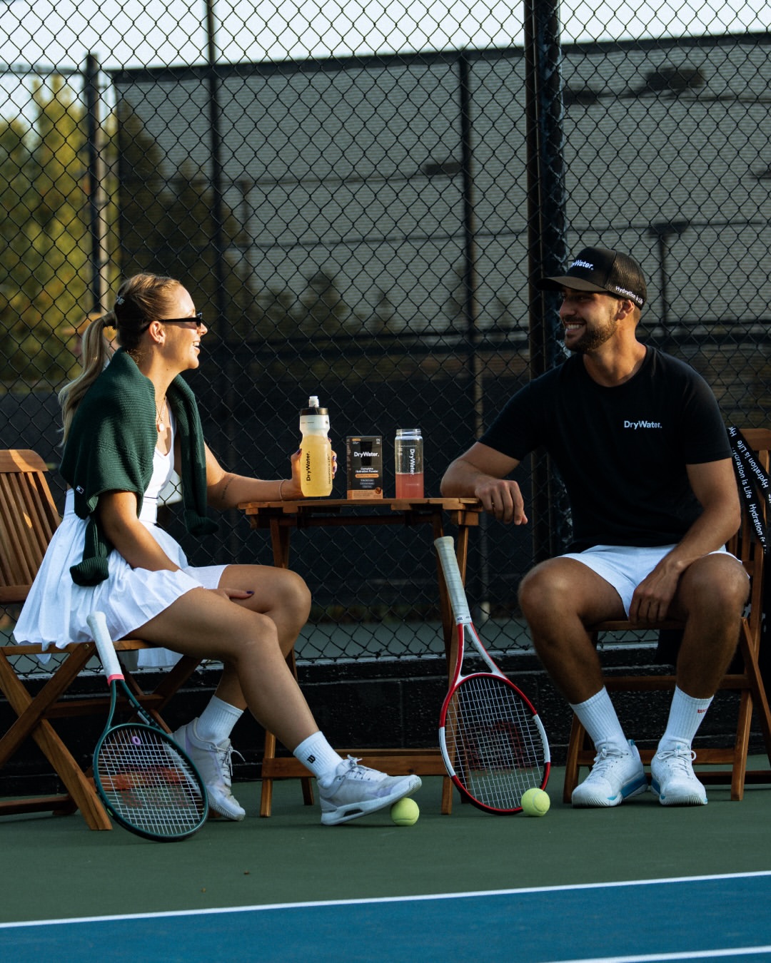 Two players courtside with DryWater bottles and hydration sticks